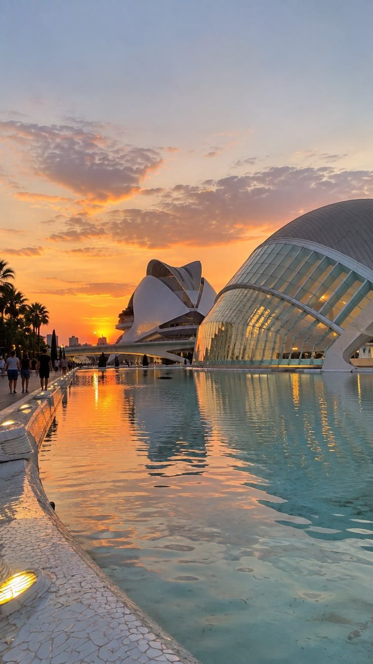 The City of Arts and Sciences at dusk, its white curves mirrored in the water
