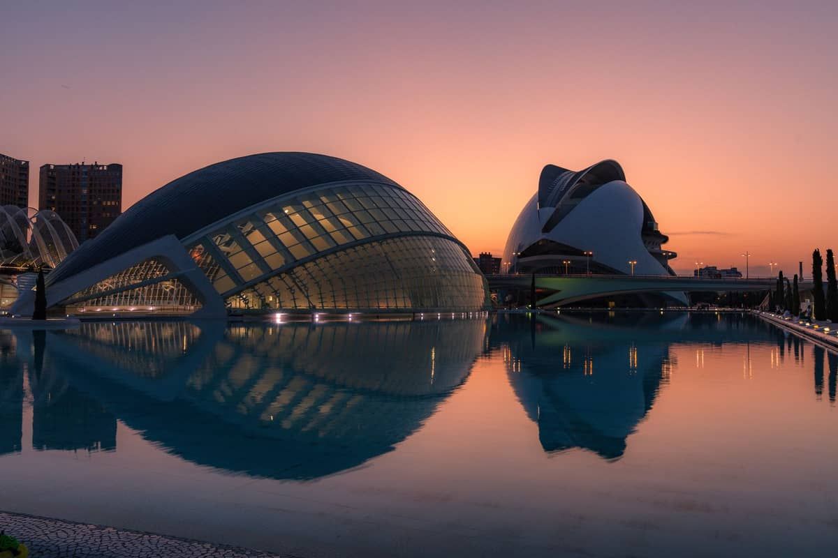 The City of Arts and Sciences reflected in its still pools at sunset